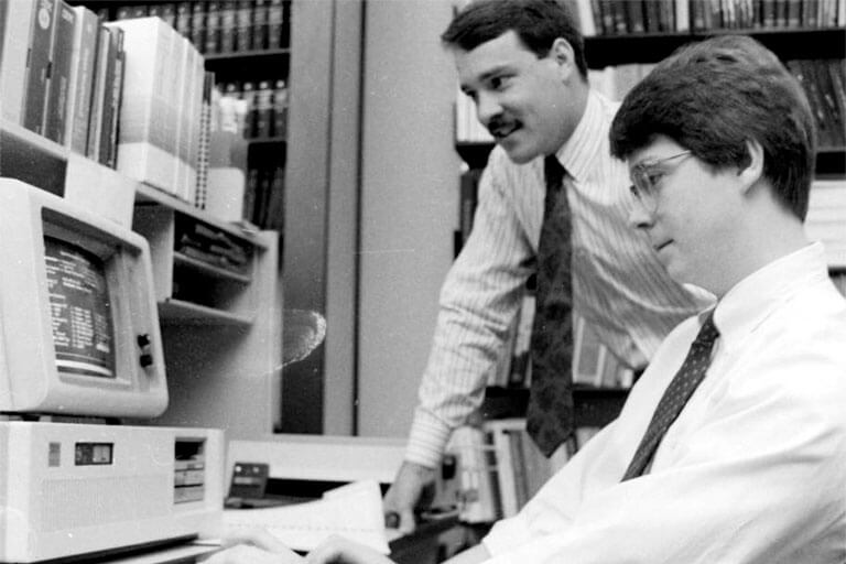 A student working at a computer in the 1980's